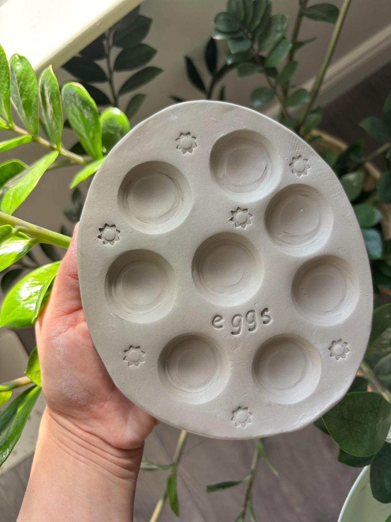 An unfired stoneware egg tray, still raw grey clay